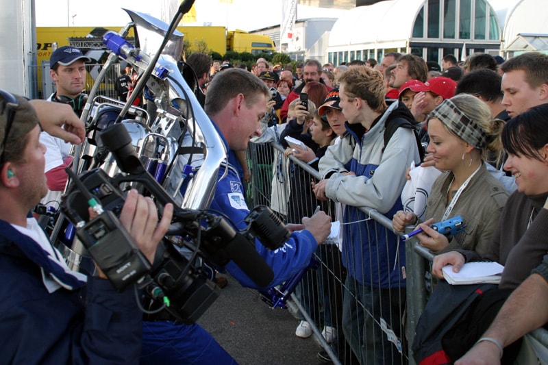 The Rocketman signing autographs for fans at a German motorsport event