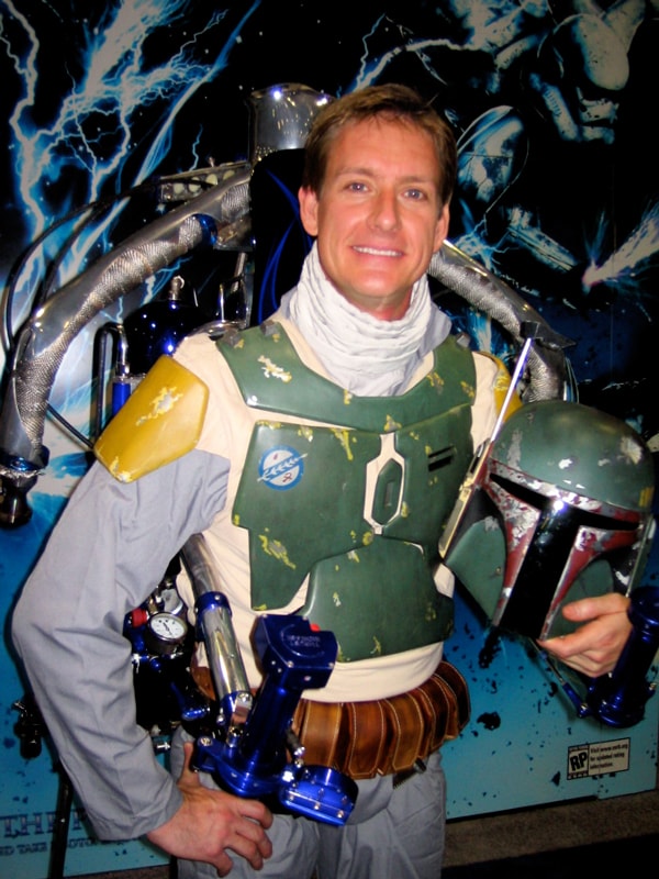 The Rocketman in Boba Fett costume holding the helmet