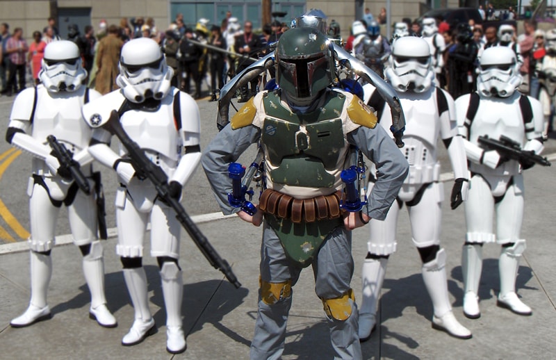 The Rocketman as Boba Fett flanked by Stormtroopers outdoors