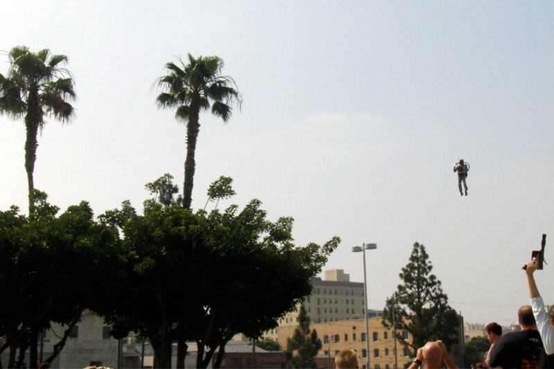 The Rocketman as Boba Fett flying in over palm trees and a crowd