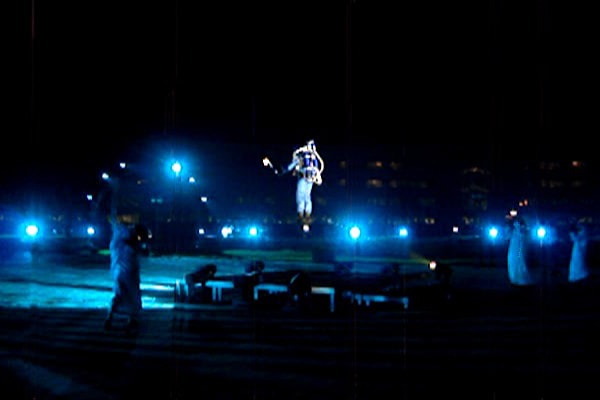 The Rocketman flying at night under blue stage lights in Abu Dhabi