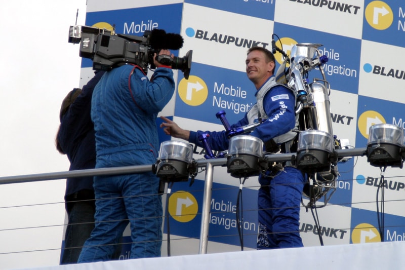 The Rocketman being interviewed by a TV crew at a Blaupunkt motorsport event