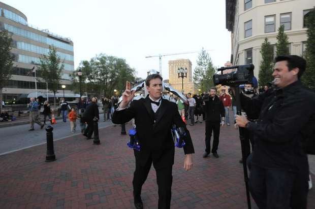 The Rocketman in a tuxedo with the rocketbelt making a James Bond entrance