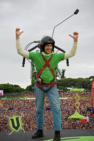 The Rocketman arms raised in triumph before a crowd of over 100,000 people
